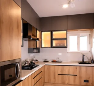 Contemporary L-shaped kitchen interior featuring pastel lower cabinets, open shelving, integrated appliances, and under-cabinet lighting